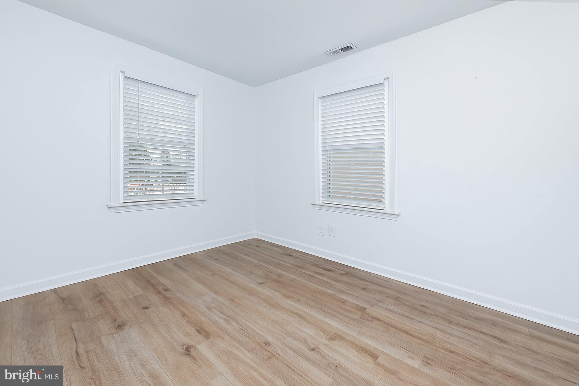 225 Spruce Street Haddonfield, NJ 08033 - Photo 24 of 28 an empty room with wooden floor and windows