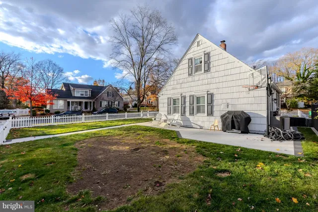 a view of a house with a big yard and sitting area
