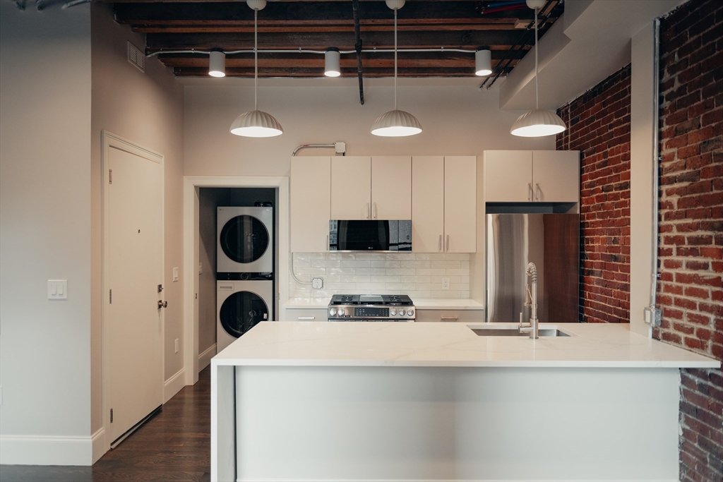 281 Franklin Street, Unit 503 Boston, MA 02110 - Photo 1 of 6 a kitchen with a refrigerator and a sink