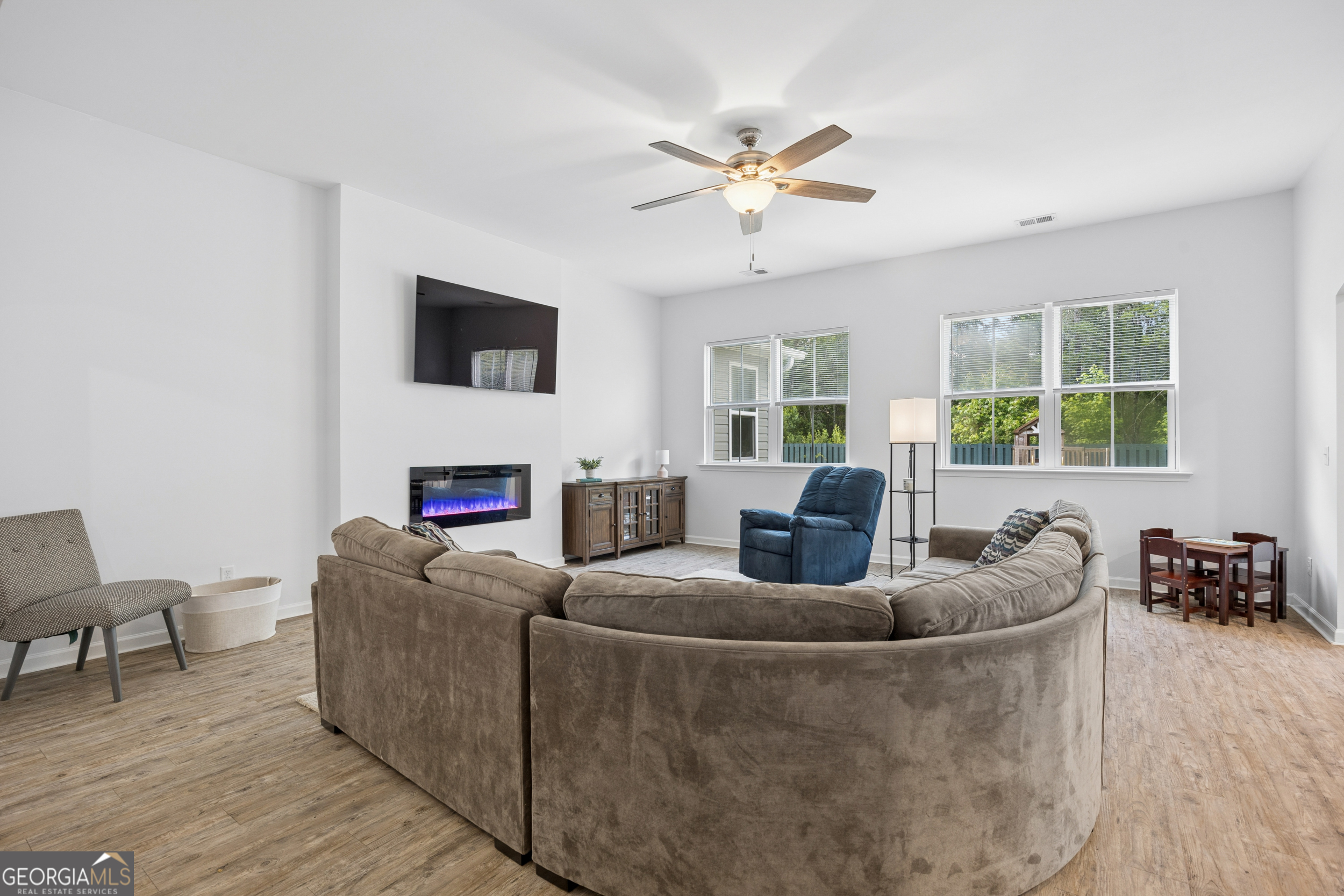 369 Waybridge Way Richmond Hill, GA 31324 - Photo 7 of 40 a living room with furniture and a flat screen tv
