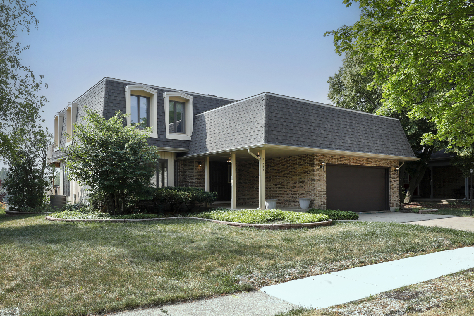1975 Brookside Lane Hoffman Estates, IL 60169 - Photo 1 of 32 a front view of a house with a yard and garage