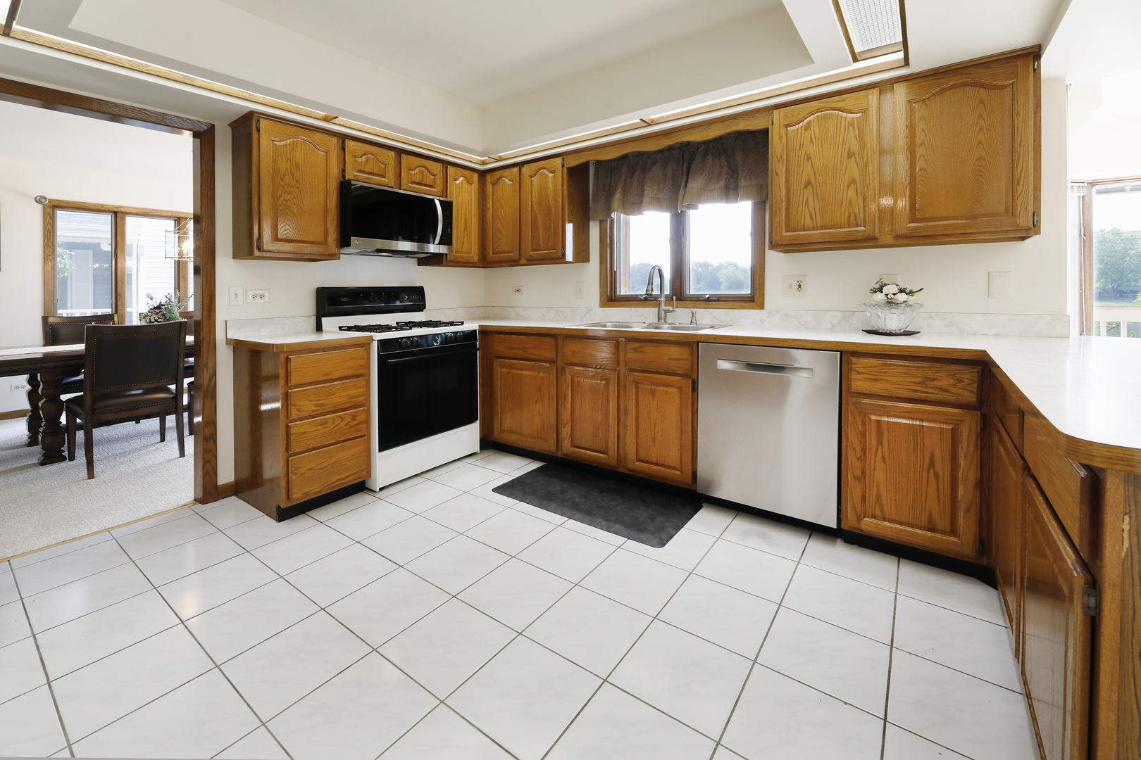 1975 Brookside Lane Hoffman Estates, IL 60169 - Photo 7 of 32 a kitchen with stainless steel appliances granite countertop a stove a sink and a microwave