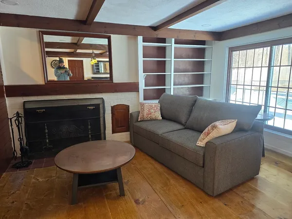 a view of a dining room with furniture and a window