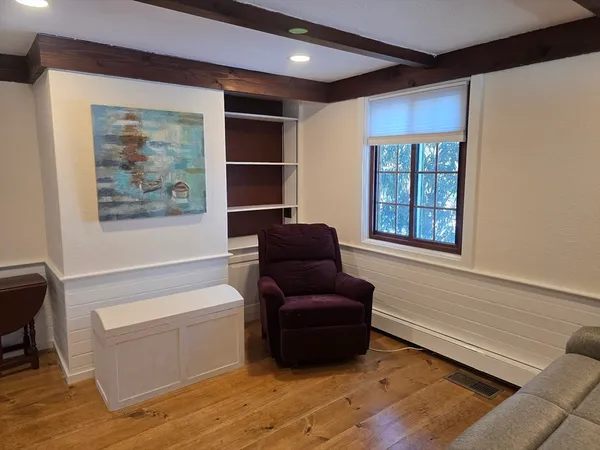 a view of an empty room with wooden floor