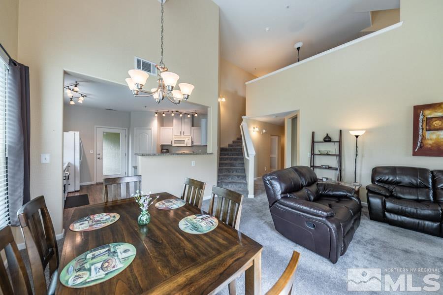 9050 Double R Boulevard Reno, NV 89521 - Photo 16 of 40 a living room with furniture and a chandelier
