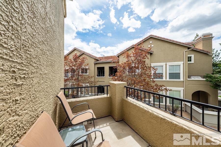 9050 Double R Boulevard Reno, NV 89521 - Photo 18 of 40 a balcony with table and chairs