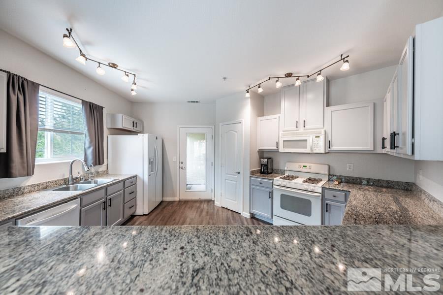 9050 Double R Boulevard Reno, NV 89521 - Photo 21 of 40 a kitchen with stainless steel appliances granite countertop a stove a sink and a refrigerator