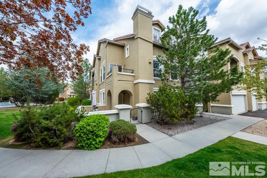 9050 Double R Boulevard Reno, NV 89521 - Photo 4 of 40 a front view of a house with a garden