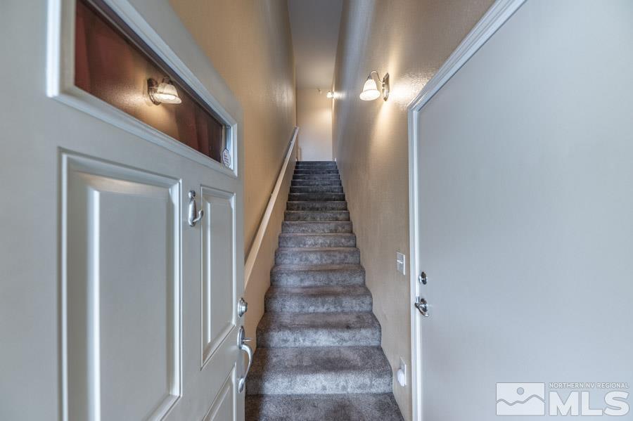 9050 Double R Boulevard Reno, NV 89521 - Photo 10 of 40 a view of a hallway with wooden floor and staircase