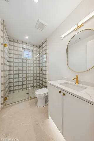 a bathroom with a toilet sink and shower