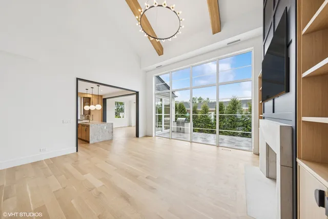 a view of an empty room with a floor to ceiling window and a ceiling fan