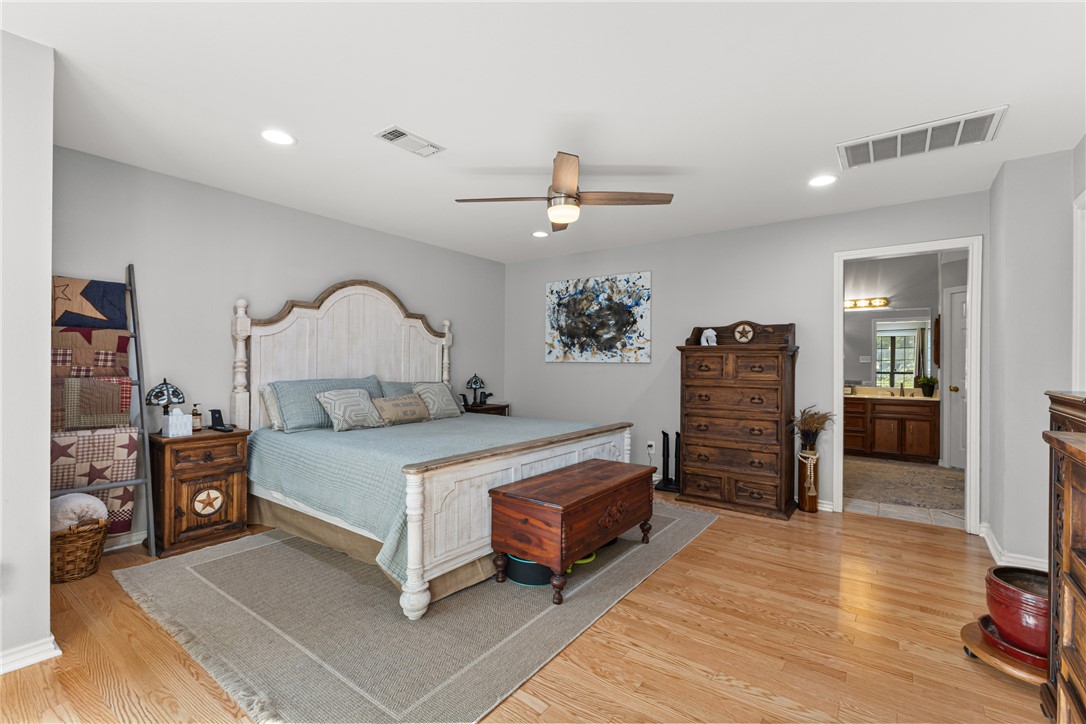 31928 Reids Prairie Road Waller, TX 77484 - Photo 20 of 43 Bedroom with light wood-style floors, recessed lighting, a ceiling fan, and ensuite bath
