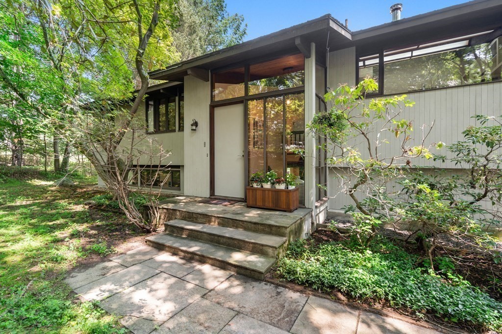 20 Meadowbrook Road Westwood, MA 02090 - Photo 2 of 36 a backyard of a house with table and chairs under an umbrella