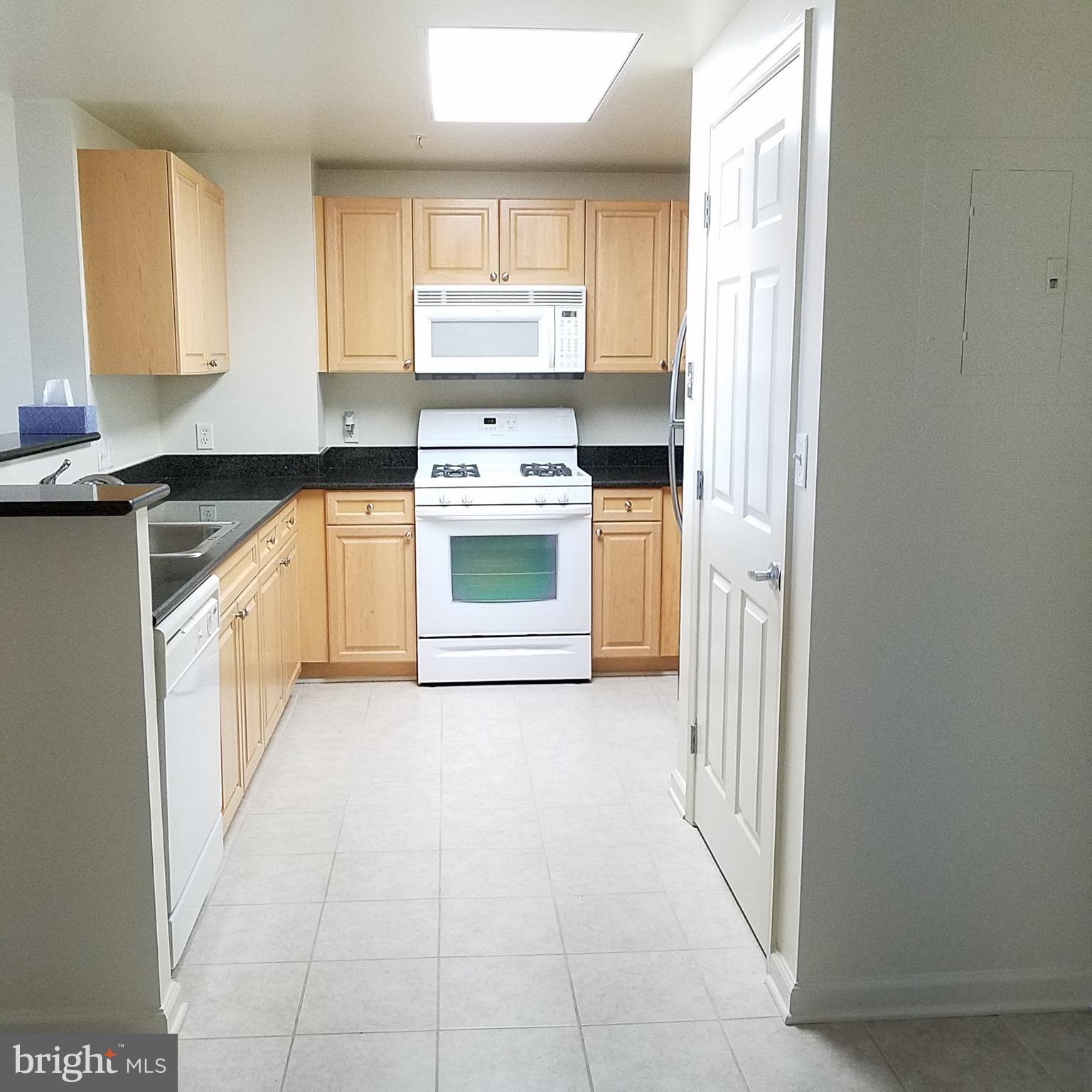 2726 Gallows Road, Unit 1104 Vienna, VA 22180 - Photo 10 of 37 a kitchen with stainless steel appliances granite countertop a stove and a refrigerator