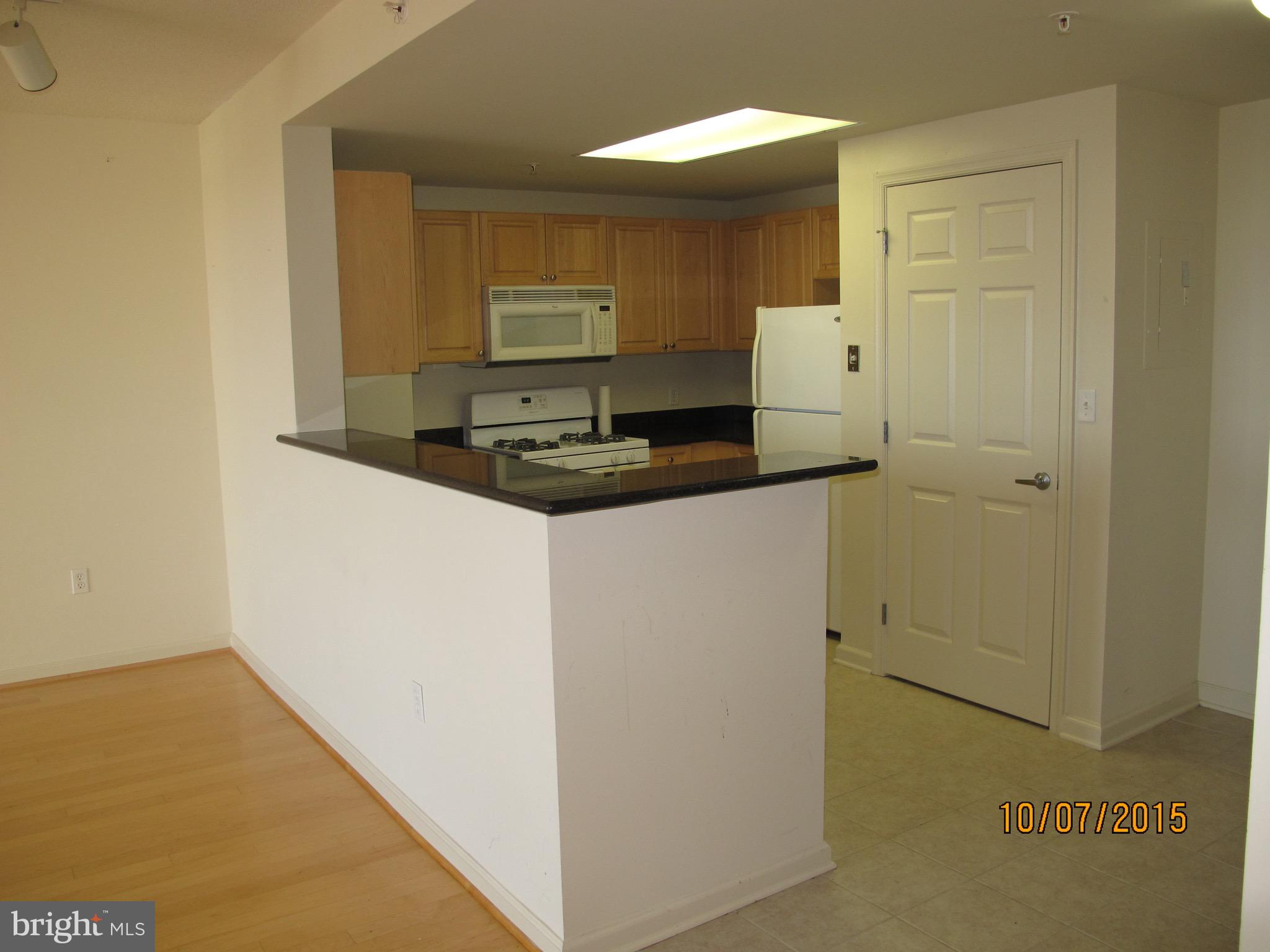 2726 Gallows Road, Unit 1104 Vienna, VA 22180 - Photo 8 of 37 a kitchen with a sink and refrigerator