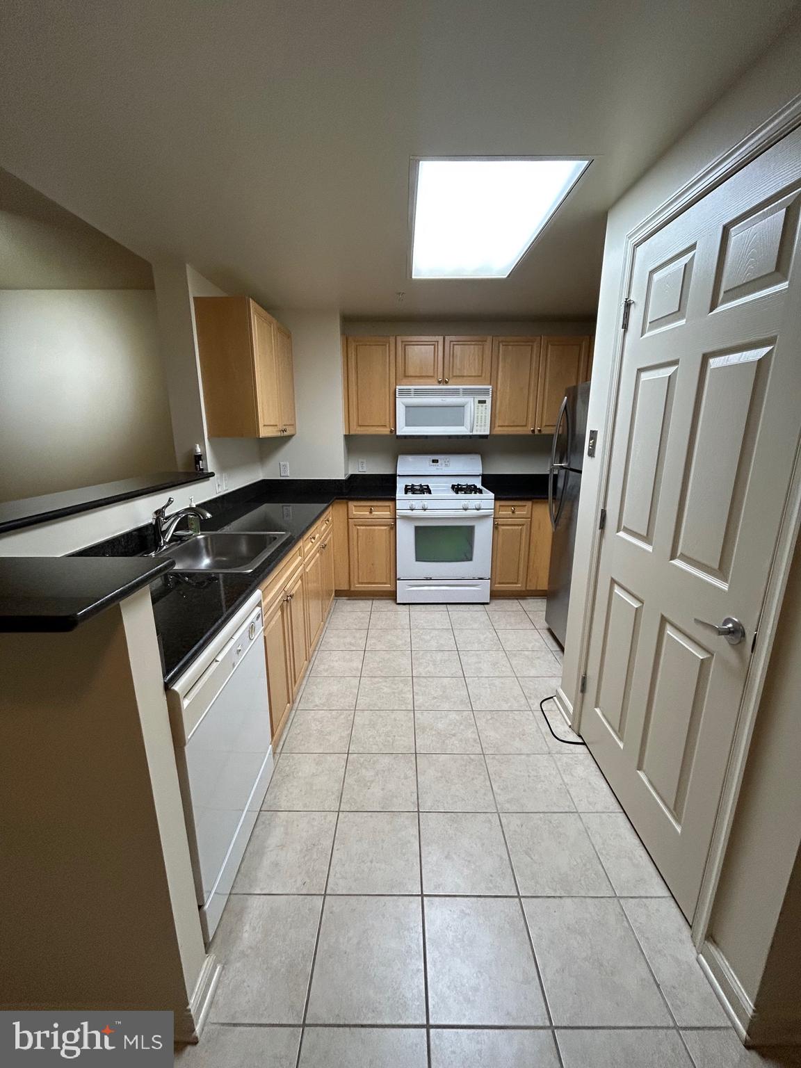 2726 Gallows Road, Unit 1104 Vienna, VA 22180 - Photo 9 of 37 a kitchen with a sink a stove top oven and cabinets