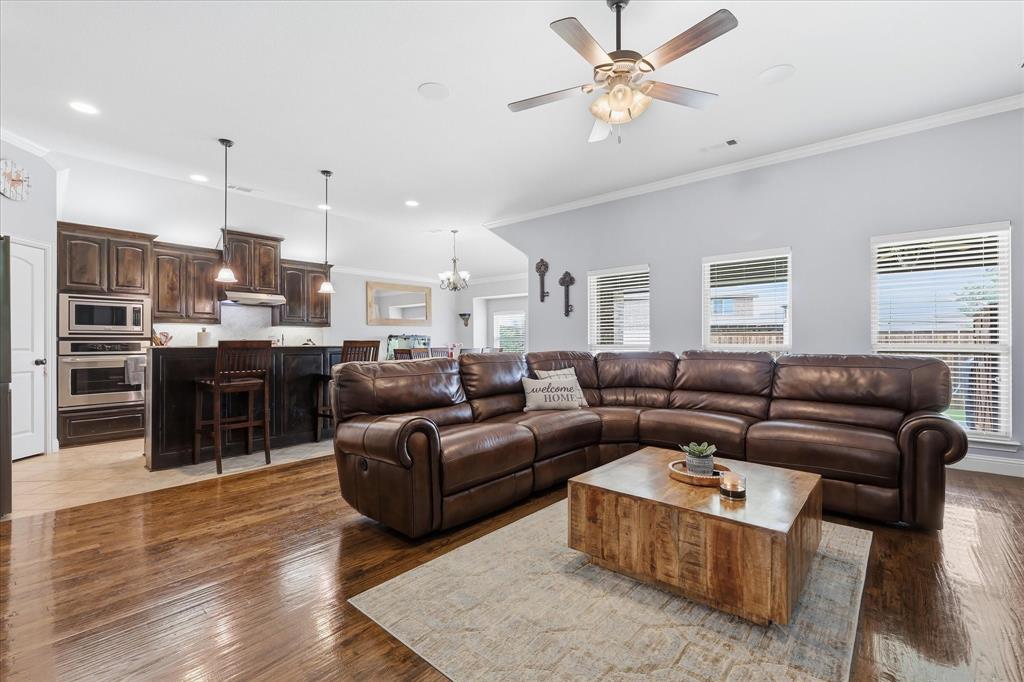 1105 Safrano Street Midlothian, TX 76065 - Photo 4 of 25 a living room with furniture kitchen view and a wooden floor