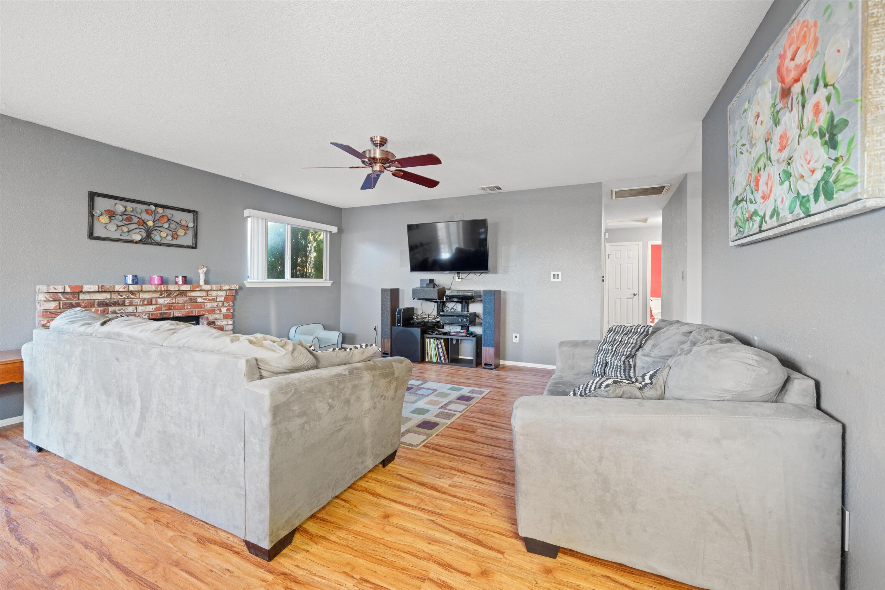3525 West Roxbury Street Rosamond, CA 93560 - Photo 12 of 26 a living room with furniture and a flat screen tv