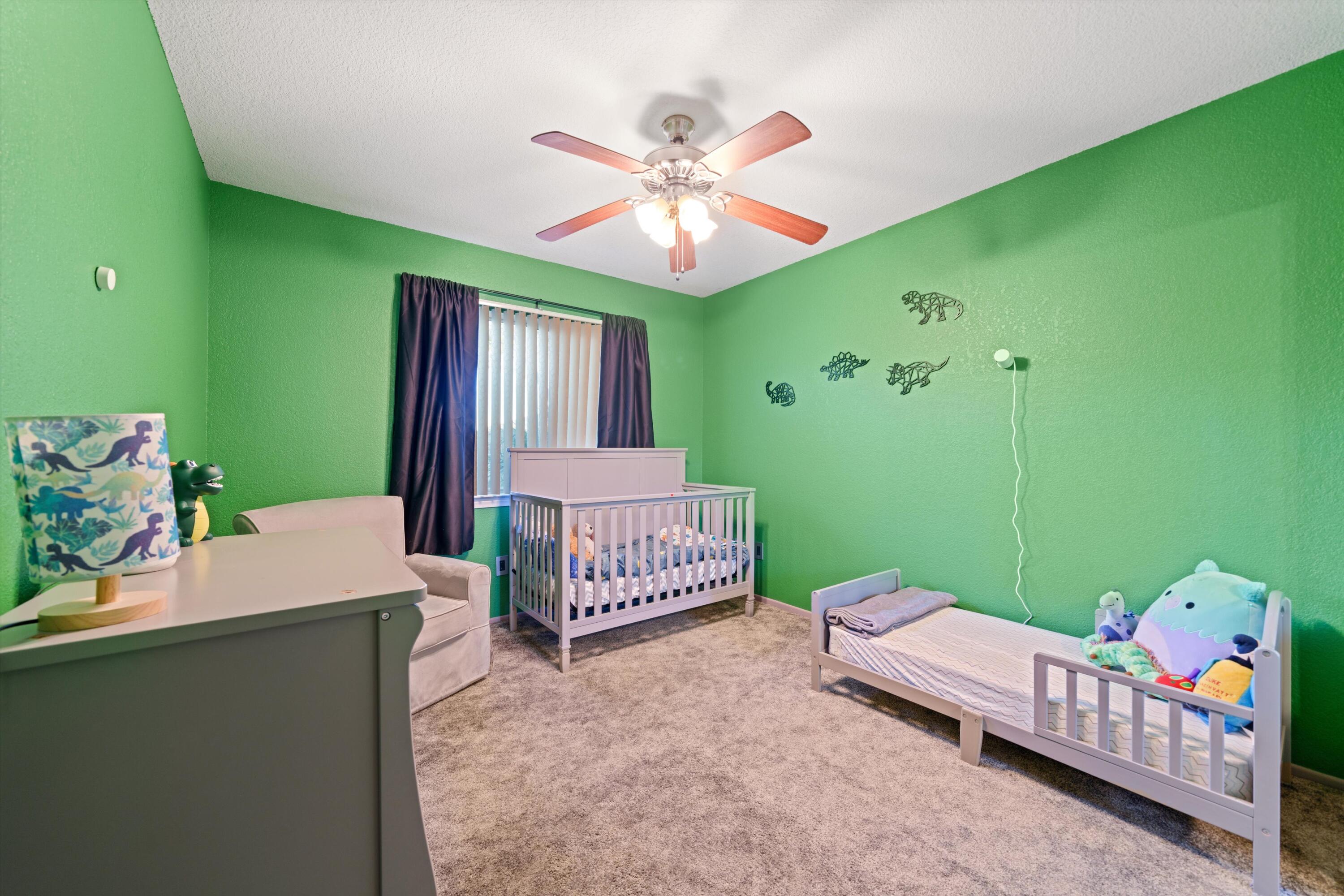 3525 West Roxbury Street Rosamond, CA 93560 - Photo 14 of 26 a bedroom with a bed table and a window