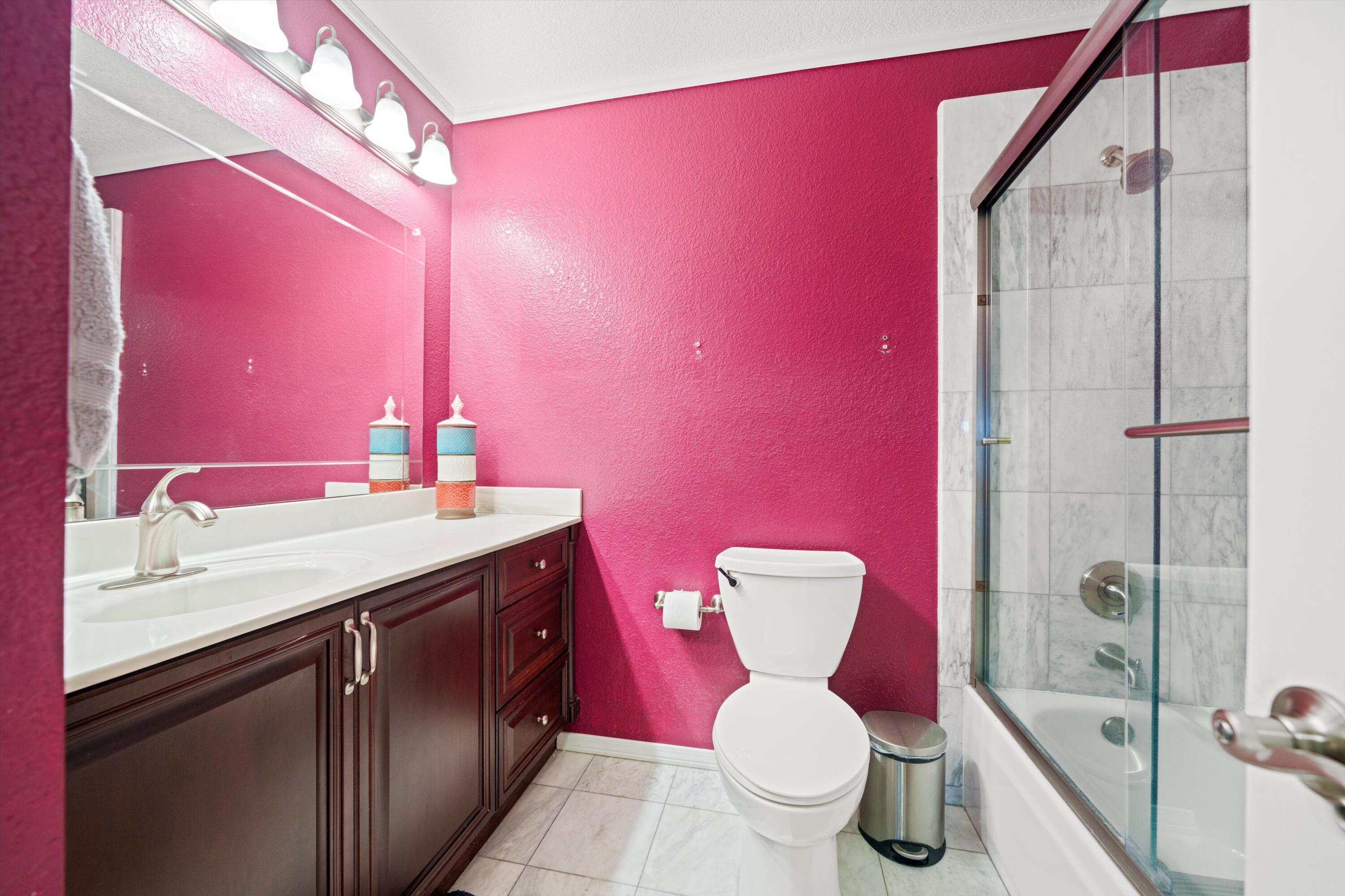 3525 West Roxbury Street Rosamond, CA 93560 - Photo 15 of 26 a bathroom with a granite countertop toilet sink and mirror