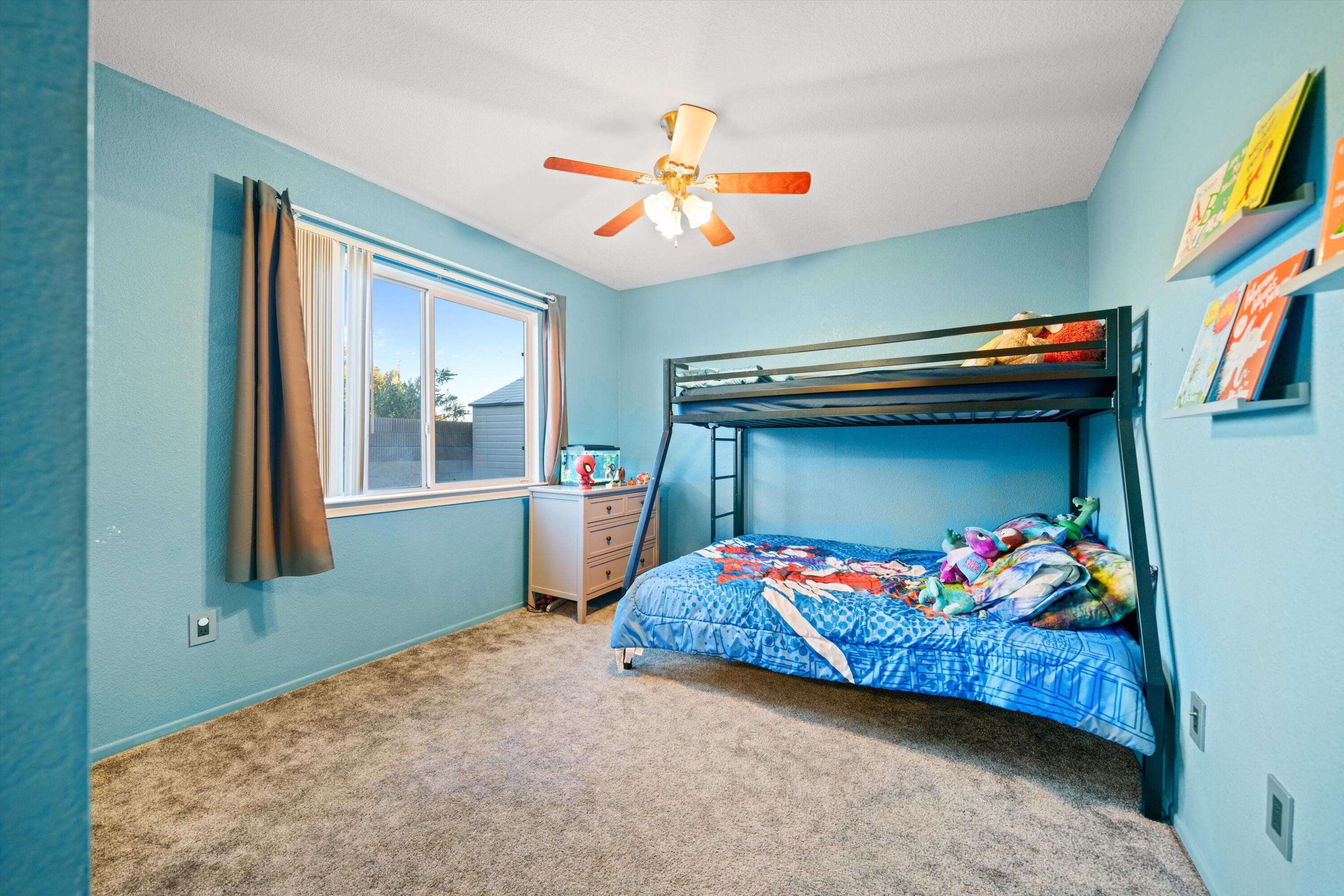 3525 West Roxbury Street Rosamond, CA 93560 - Photo 16 of 26 a bedroom with a bed and window