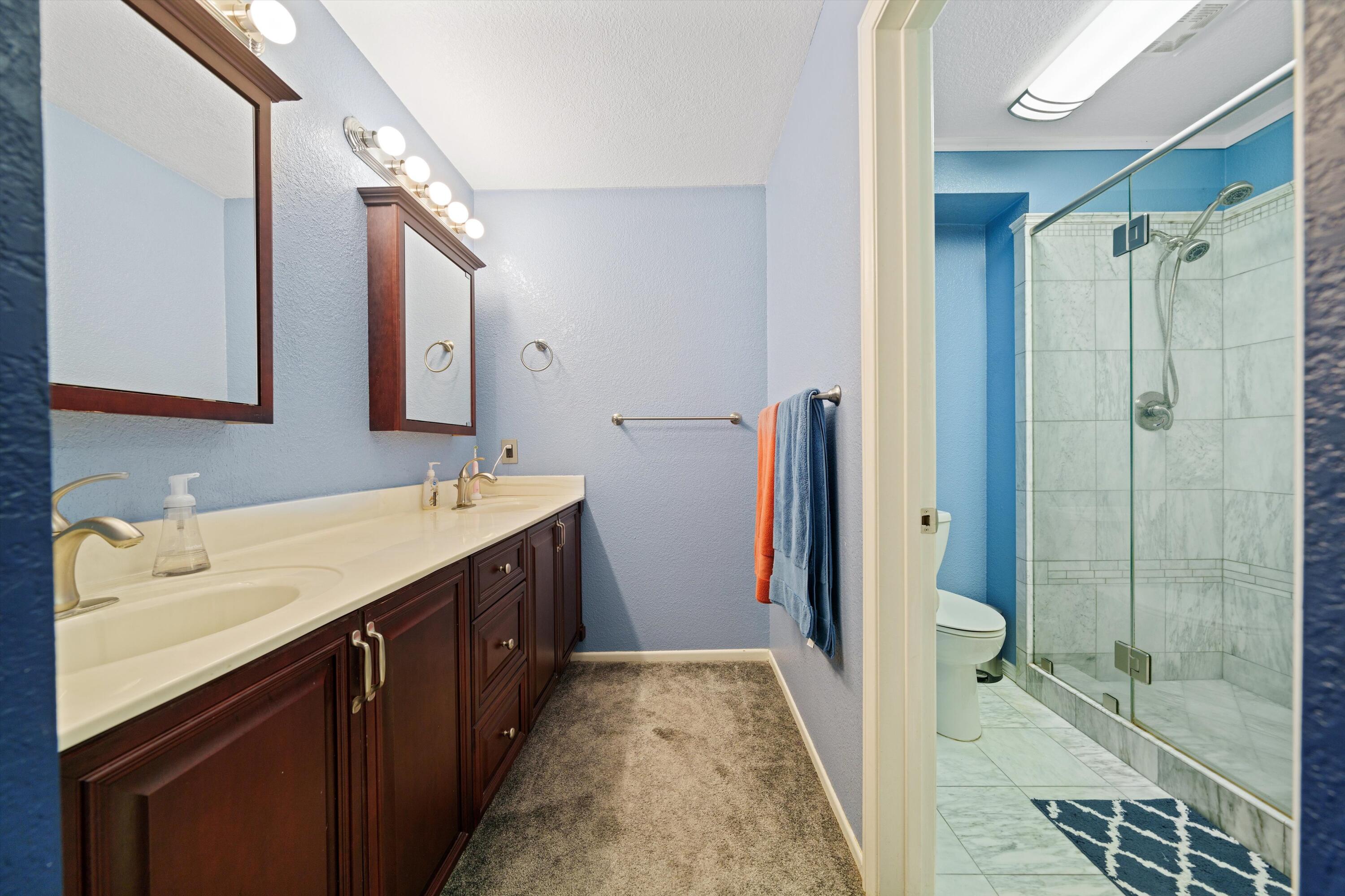 3525 West Roxbury Street Rosamond, CA 93560 - Photo 19 of 26 a spacious bathroom with a shower sink and mirror