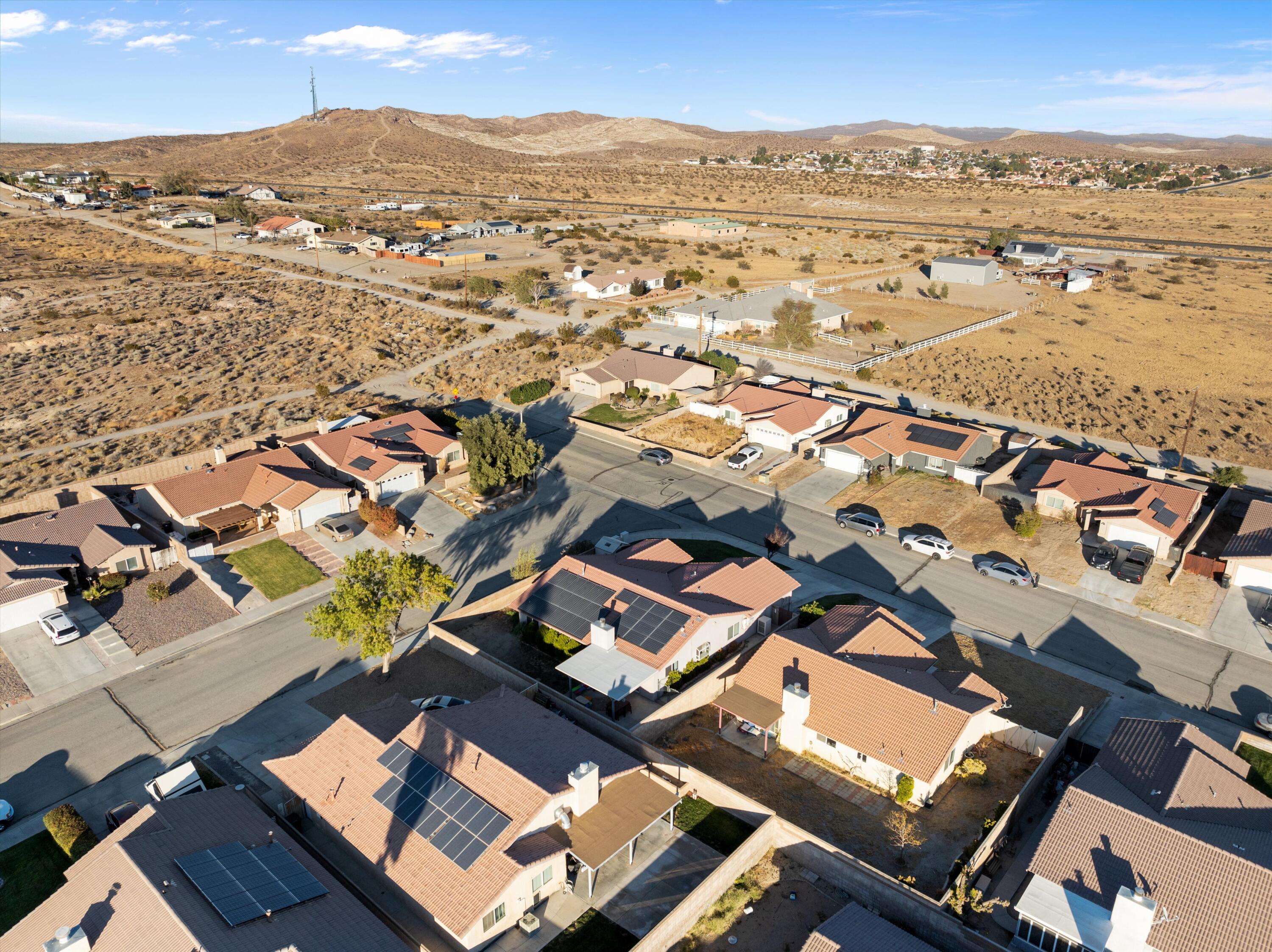 3525 West Roxbury Street Rosamond, CA 93560 - Photo 23 of 26 an aerial view of residential building with parking