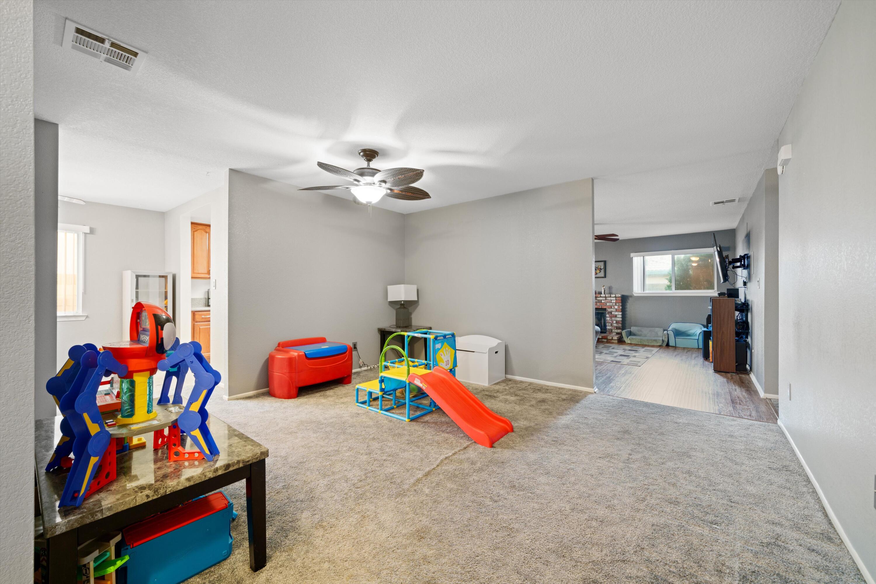 3525 West Roxbury Street Rosamond, CA 93560 - Photo 5 of 26 a living room with lots of baby toys