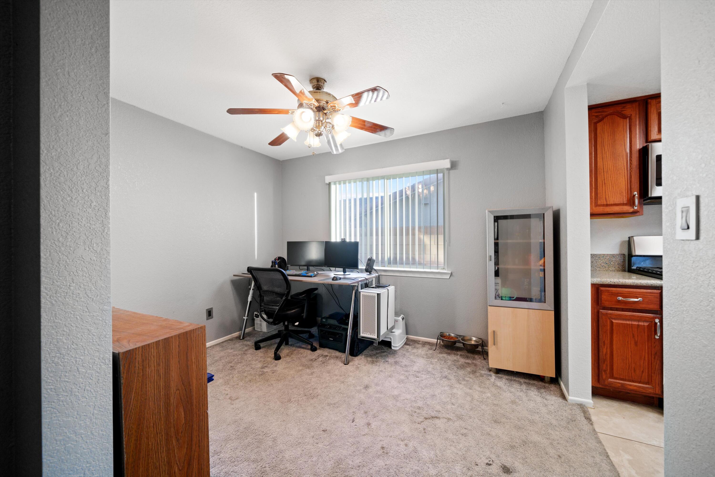 3525 West Roxbury Street Rosamond, CA 93560 - Photo 6 of 26 a view of a workspace with furniture and a window