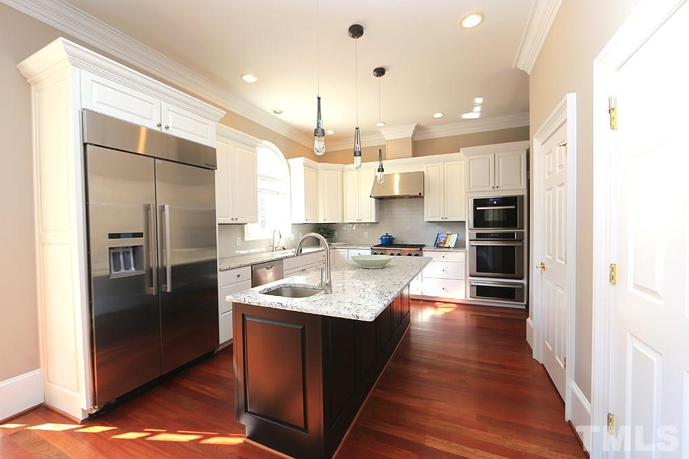 5216 Wynneford Way Raleigh, NC 27614 - Photo 13 of 28 The pictures don't do the kitchen justice. Come see for yourself...tons of counter space, a huge island with vegetable sink, high-end appliances are several years new, remodeled with painted cabinets, new granite and tile backsplash and faucets.