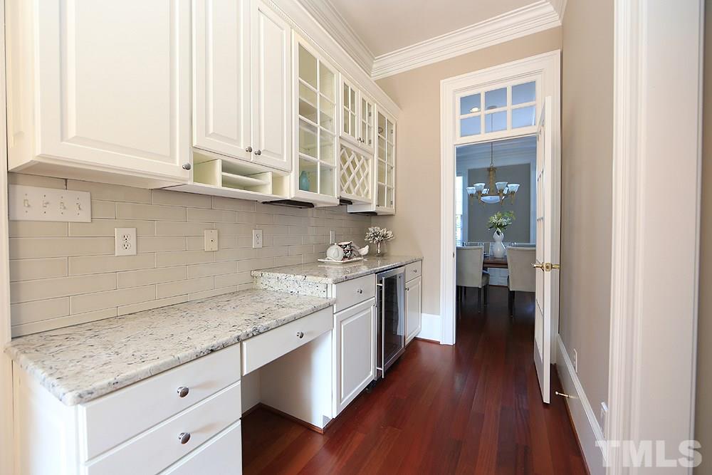 5216 Wynneford Way Raleigh, NC 27614 - Photo 15 of 28 The butler's pantry has a desk area, beverage fridge and cabinets to display your finest wares.