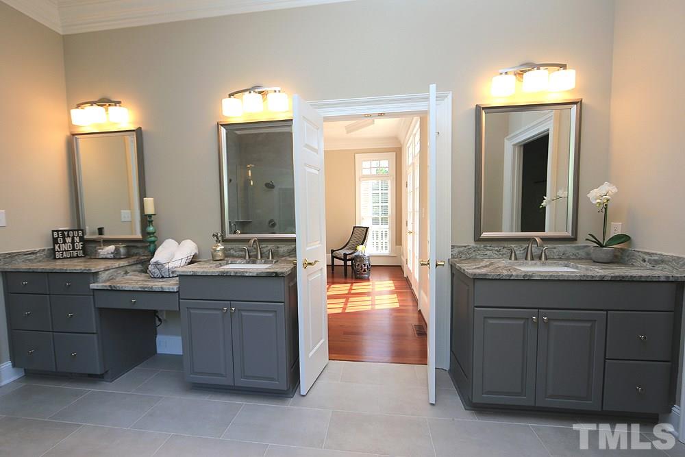 5216 Wynneford Way Raleigh, NC 27614 - Photo 17 of 28 The master bath has been remodeled with a painted cabinetry, leathered marble counters, new lights and faucets, large free-standing soaking tub and huge walk-in shower with 2 shower heads. There is a separate commode room with window.