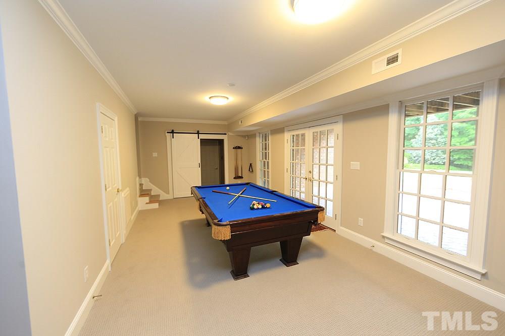 5216 Wynneford Way Raleigh, NC 27614 - Photo 23 of 28 The basement has room for a pool table plus a gathering area, home theatre and office, in addition to tons of walk-in storage. The windows and french doors have been replace and have no grates in them. The barn door leads to the home theatre.
