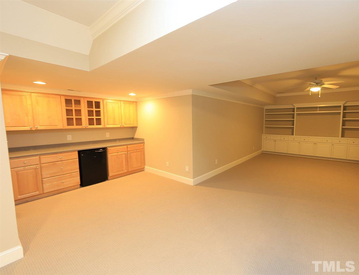 5216 Wynneford Way Raleigh, NC 27614 - Photo 25 of 28 The gathering area in the basement has built-ins. There is a bar area has a mini fridge and lots of counter/cabinet space-great for entertaining. There is a full bathroom in the basement and several unfinished storage areas. There is a built-in safe too.