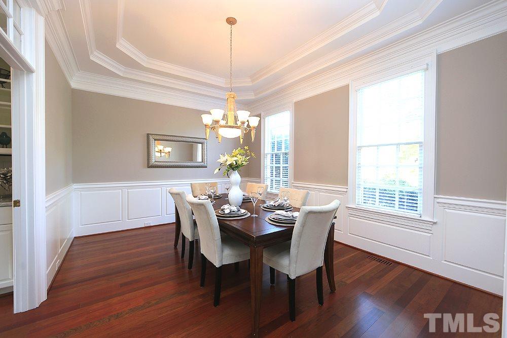 5216 Wynneford Way Raleigh, NC 27614 - Photo 6 of 28 The dining room has a tiered tray ceiling and beautiful trim detail. The custom trim detail is evident throughout the home.