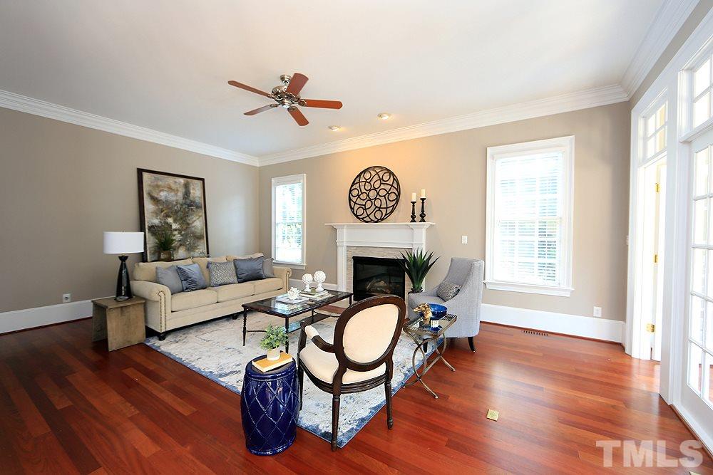 5216 Wynneford Way Raleigh, NC 27614 - Photo 7 of 28 The family room is cozy and features a gas fireplace flanked by 2 windows. The surround for the fireplace was just modernized.
