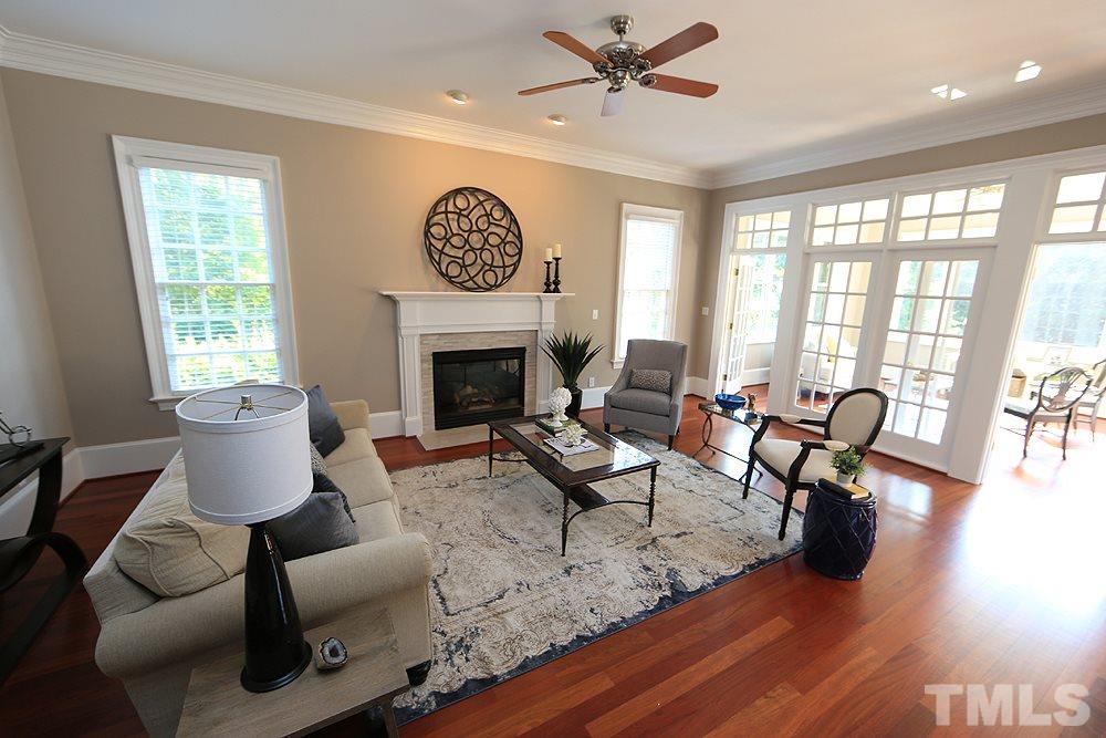 5216 Wynneford Way Raleigh, NC 27614 - Photo 8 of 28 The family room opens to the kitchen/breakfast room as well as the bright sunroom. A wall of french doors/glass separates the sunroom from the family room.