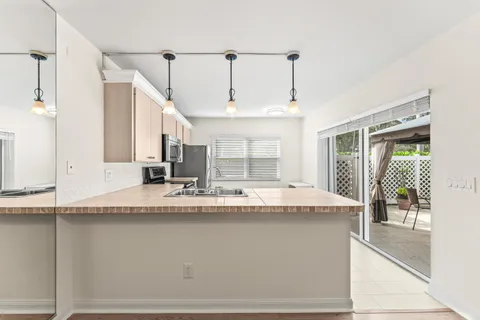 a kitchen with stainless steel appliances granite countertop a sink and a refrigerator