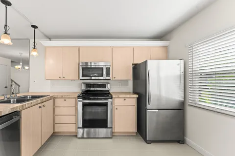 a kitchen with a refrigerator sink and stove