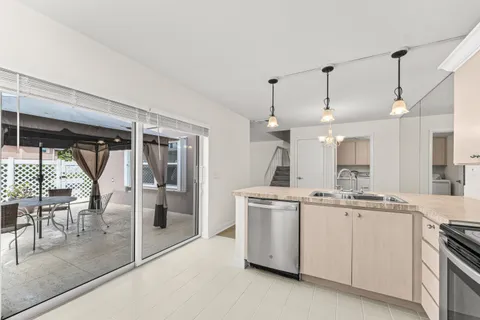 a kitchen with a sink appliances and cabinets