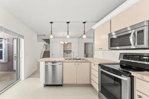 a kitchen with stainless steel appliances granite countertop a stove and a refrigerator