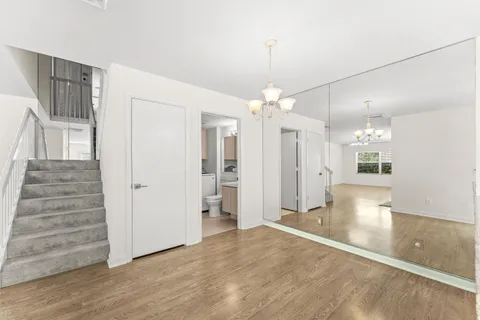 wooden floor in an empty room with a mirror