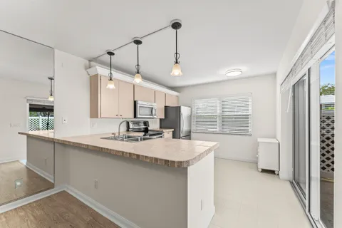 a kitchen with sink cabinets and window
