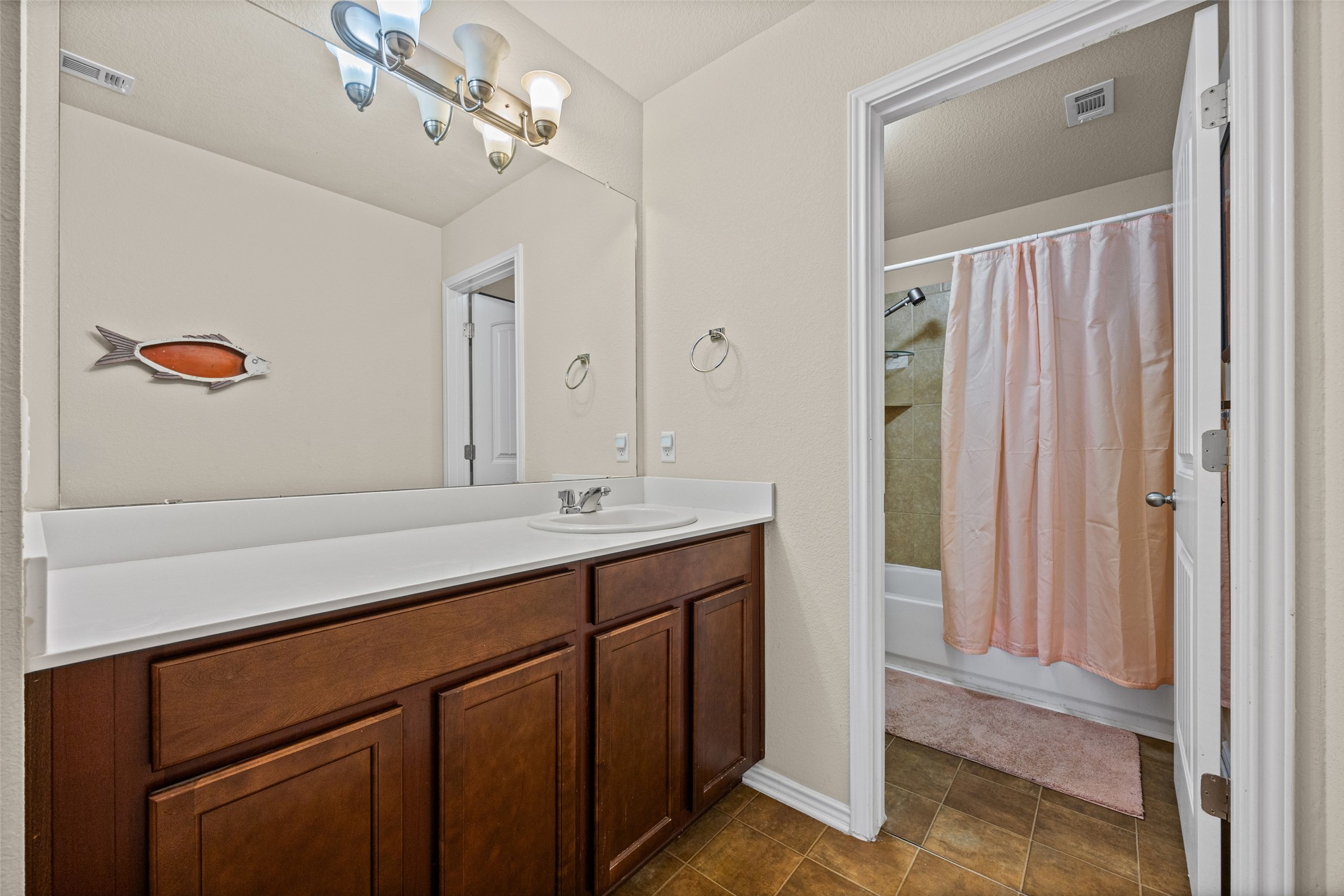 19113 Rookery Trail Pflugerville, TX 78660 - Photo 17 of 36 Bathroom featuring a dark wood-finish vanity with a white countertop and an integrated sink