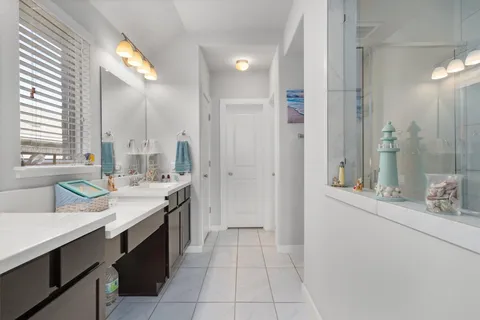 a bathroom with a double vanity sink mirror and double