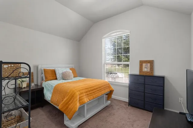 a bedroom with a bed dresser and a window