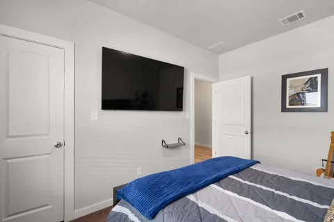a bedroom with a bed and a flat screen tv