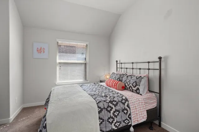 a bedroom with a bed and window