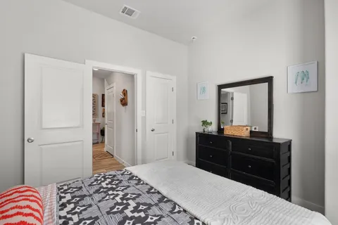 a bedroom with a bed and a dresser