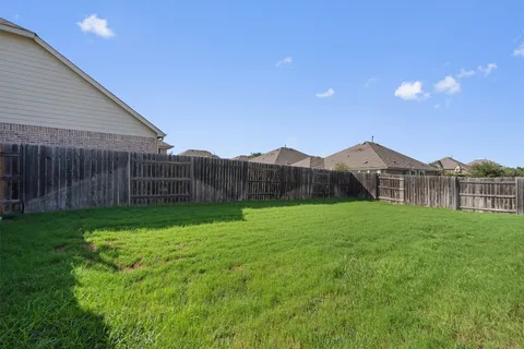 a view of an house with backyard space and garden